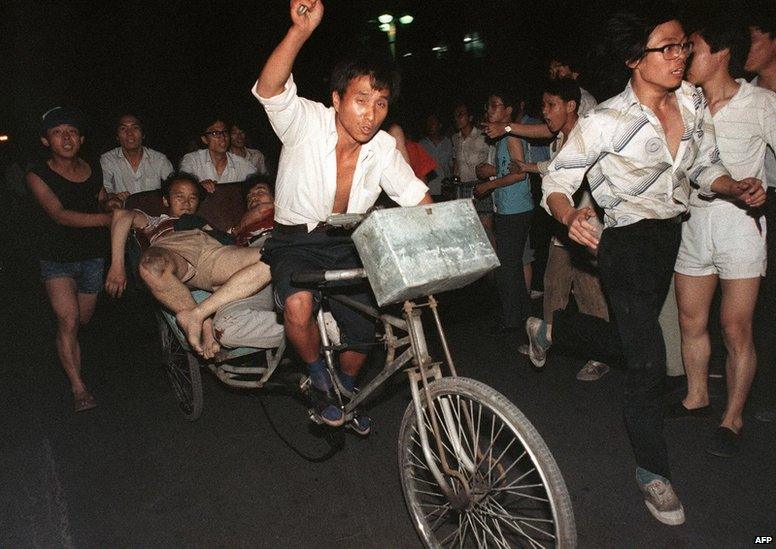 This photo, dated 4 June 1989, shows two injured people being transported during the clash between the army and students near Tiananmen Square.