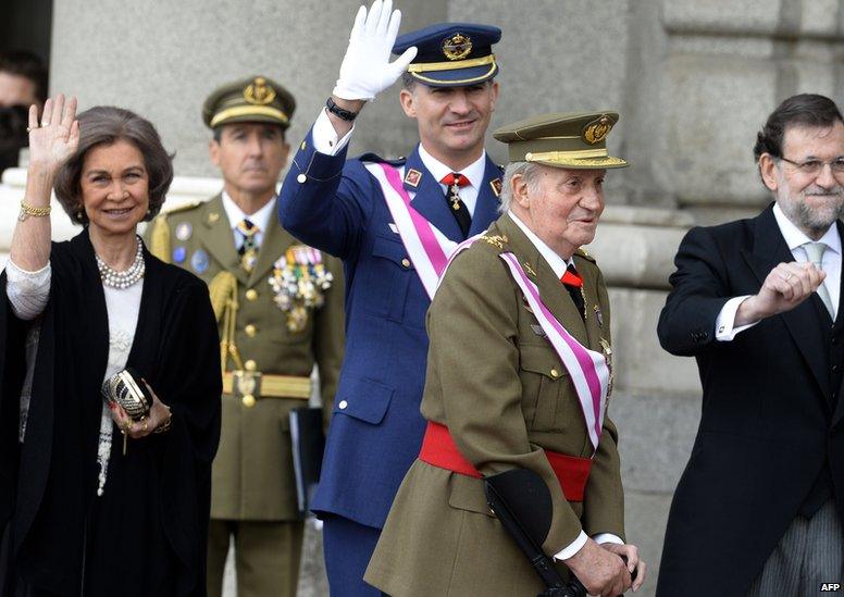 Spain's Queen Sofia (L) and Spain's Crown Prince Felipe (2ndL) and Spanish Prime Minister Mariano Rajoy (R) wave past Spain's King Juan Carlos during the Pascua Militar ceremony