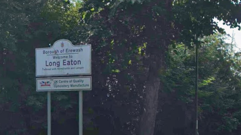 Sign which reads Long Eaton with trees behind the sign