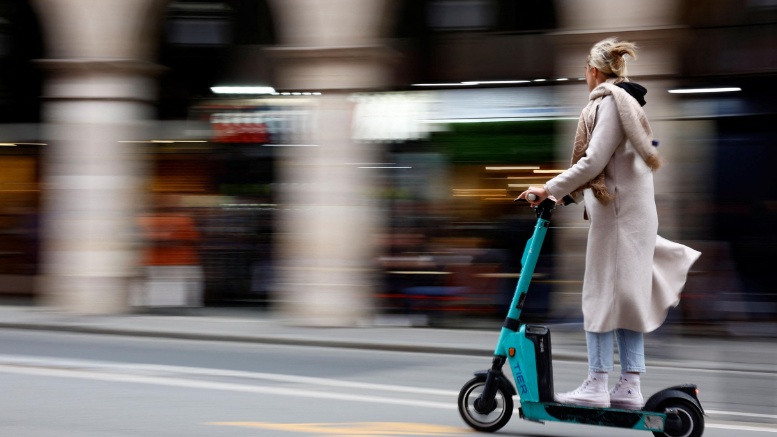 A woman on an e-scooter