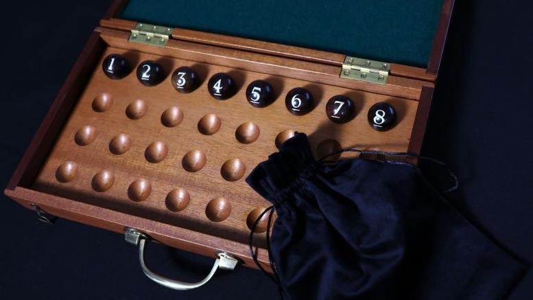 A open box showing numbered balls inside