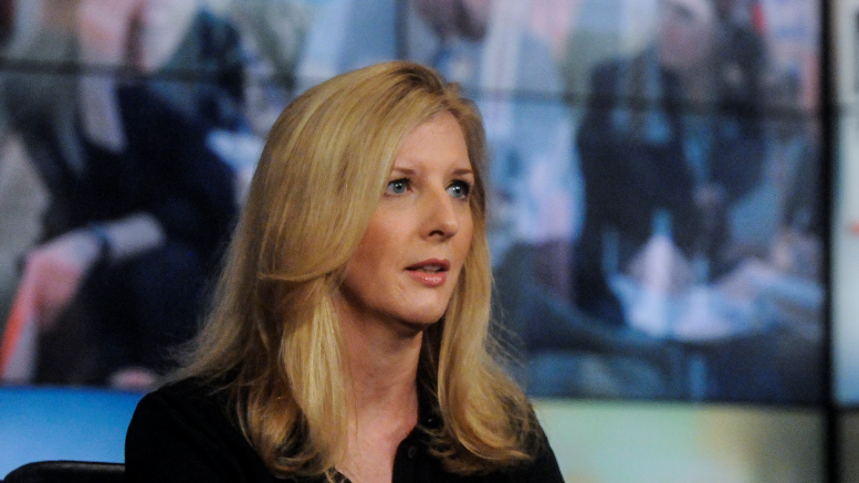 Kathy Ruemmler, with long blond hair and wearing a black top, on the set of the NBC's "Meet the Press"