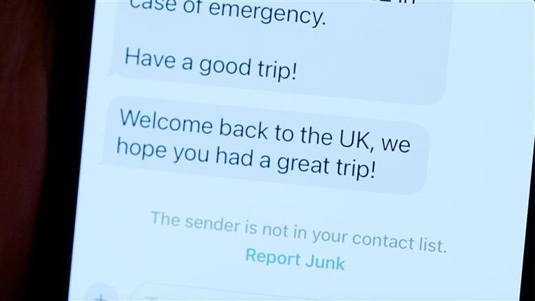 A phone showing phone messages. One message says, Have a good trip! the message sent after it says, Welcome back to the UK, we hope you had a great trip!