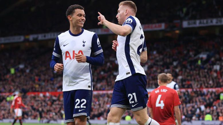 Tottenham players celebrate scoring at Manchester United earlier this season