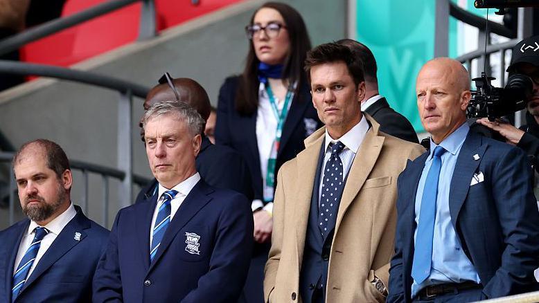 Jeremy Dale (second from left) stands in the executive box at Wembley Stadium alongside NFL legend Tom Brady and Birmingham City chairman and co-owner Tom Wagner