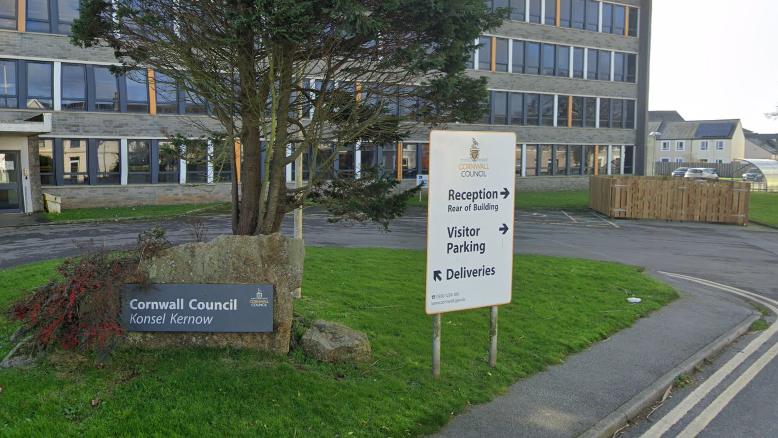 Cornwall Council building with a parking sign and a tree in front of it 