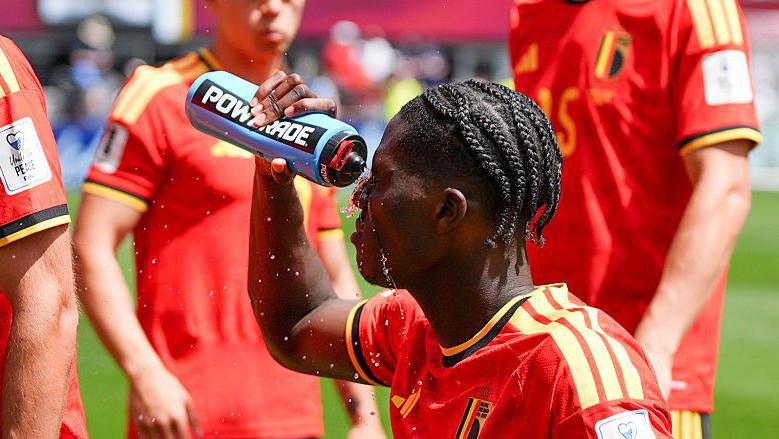 Belgium players take on water during a hydration break