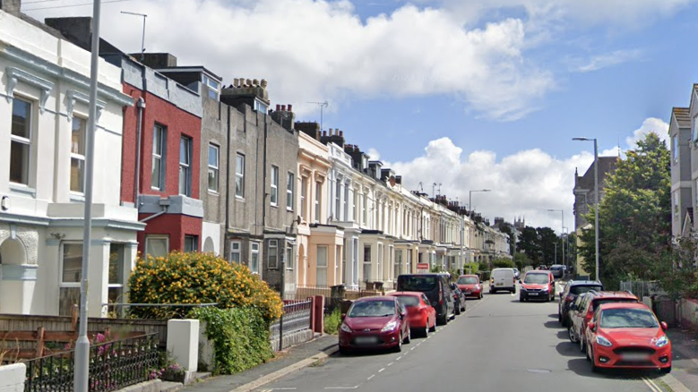 Google image of North Road West in Plymouth. Terraced properties line either side of the street. Cars are parked on both side of the road.