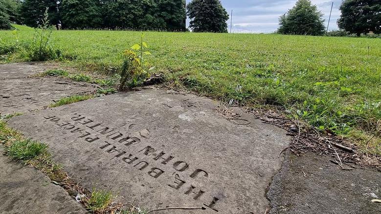 A path with the engraving 'The Burial Place of John Hunter'.