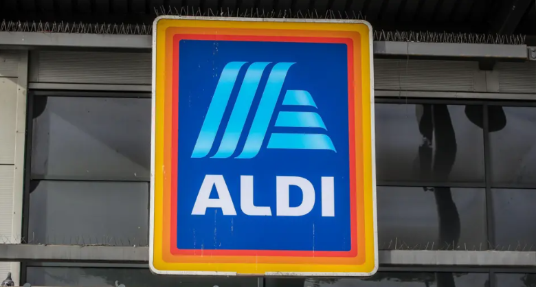 A close up image of the Aldi logo. The logo is blue in the middle and has three lines as borders. The lines go from dark to light orange. 