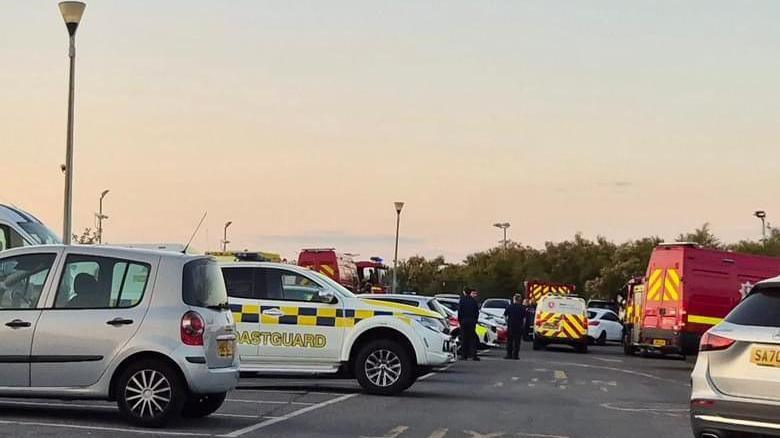 Emergency vehicles near the scene of the cliff rescue