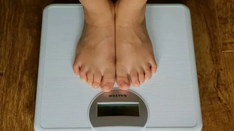 Person measuring their weight