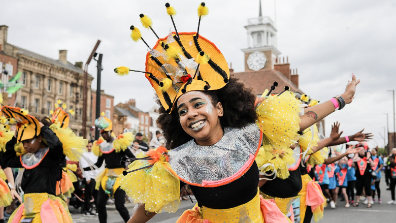 A girl dressed as a bee mid-performance.