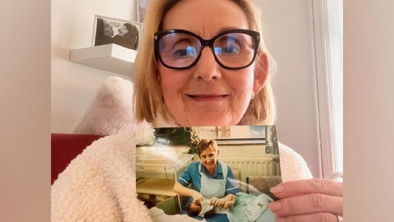 Sharon Cooling holds an image of the herself holding a newborn Katie Wintle