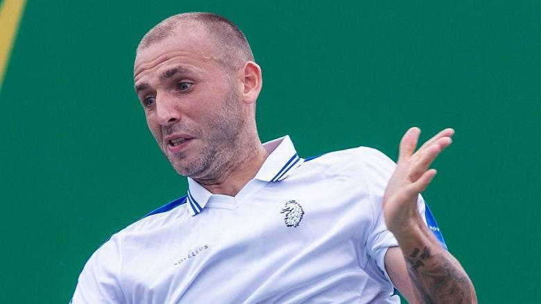 Britain's Dan Evans plays a shot