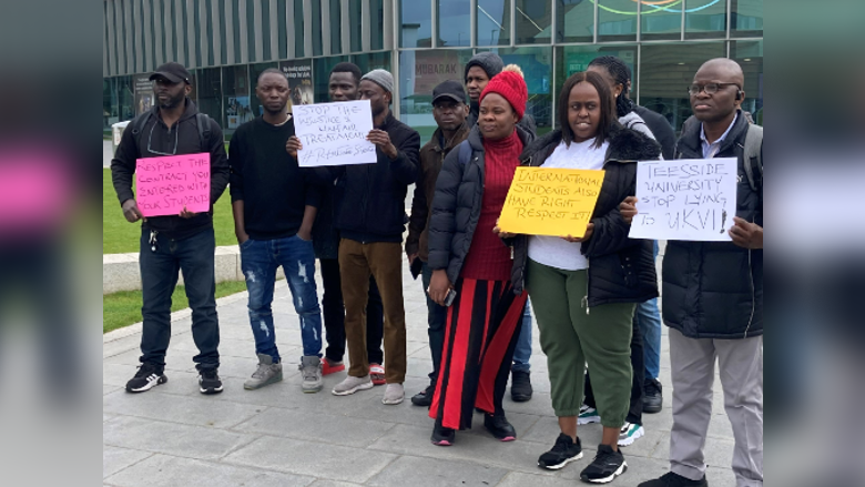 A group of Teesside University students holding placards