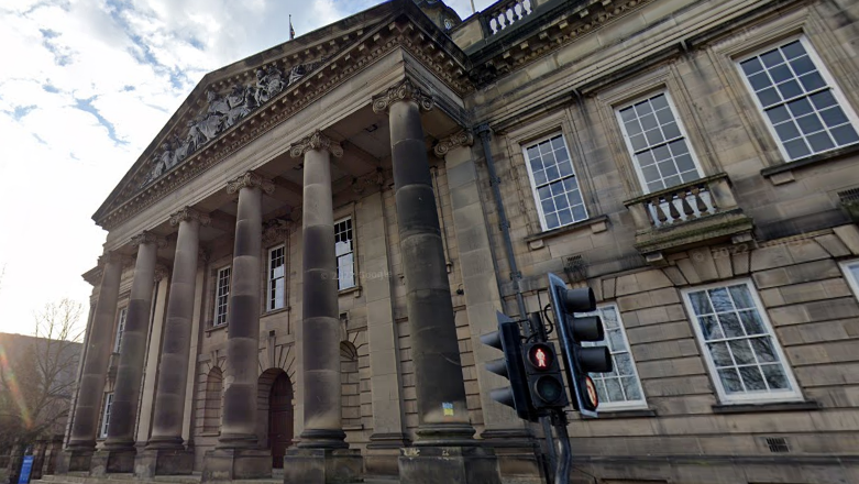 The exterior of Lancaster Town Hall, a neo-classical building with Greek ionic columns at its main entrance.