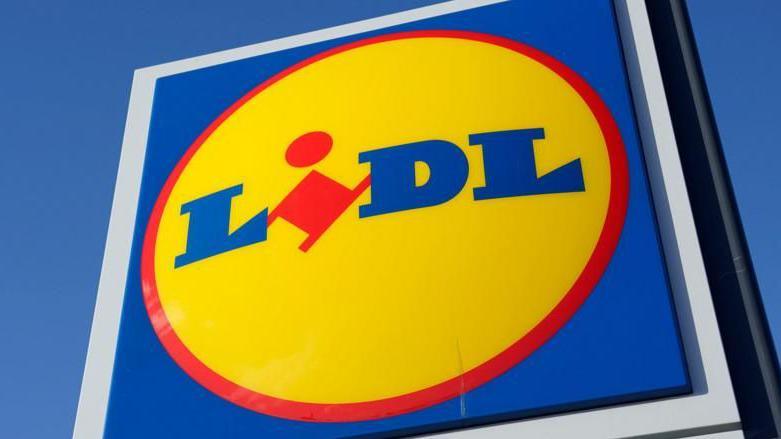 A shot of Lidl's logo on a sign, viewed from an angle looking upwards.