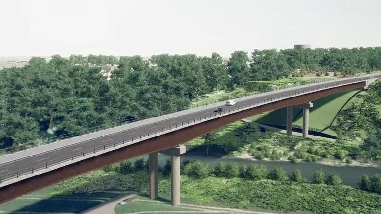 A computer-generated image of the new bypass, showing a bridge section on stilts over the river. It is surrounded by green fields and trees.