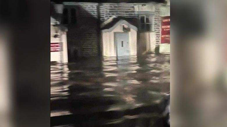 Flood waters up the side of a building in Croscombe