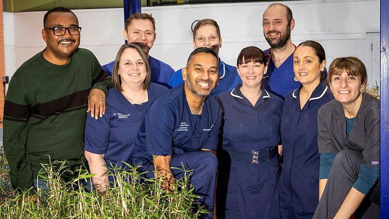 Staff from the hospital who are taking part in the challenge, smiling at the camera