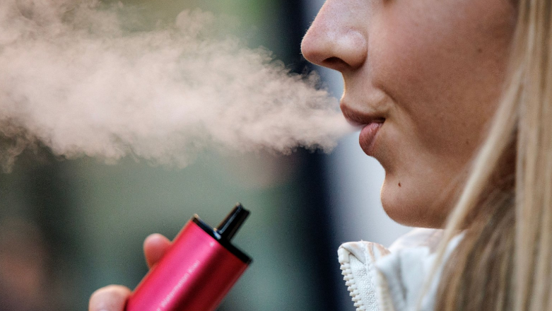 Woman using a pink vape