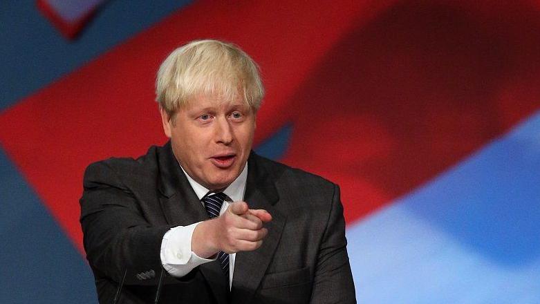 Boris Johnson points at the audience as he delivers a speech from the main stage at the 2012 Conservative conference