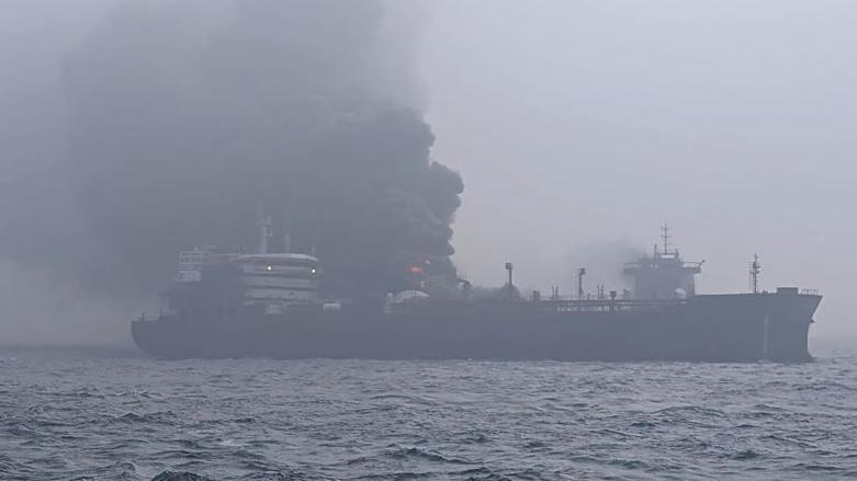 The tanker Stena Immaculate, with smoke billowing out of it.