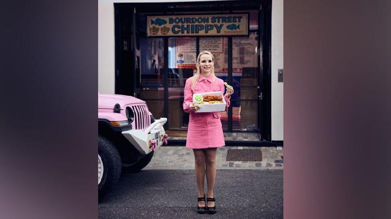 Lucy Sparrow outside her hand-stitched felt chip shop 
