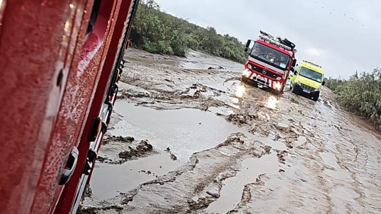 A fire engine and ambulance stuck in thick mud