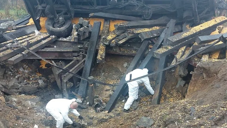 Polish forensic experts investigate a crater made by falling missile debris in eastern Poland. Photo: November 2022