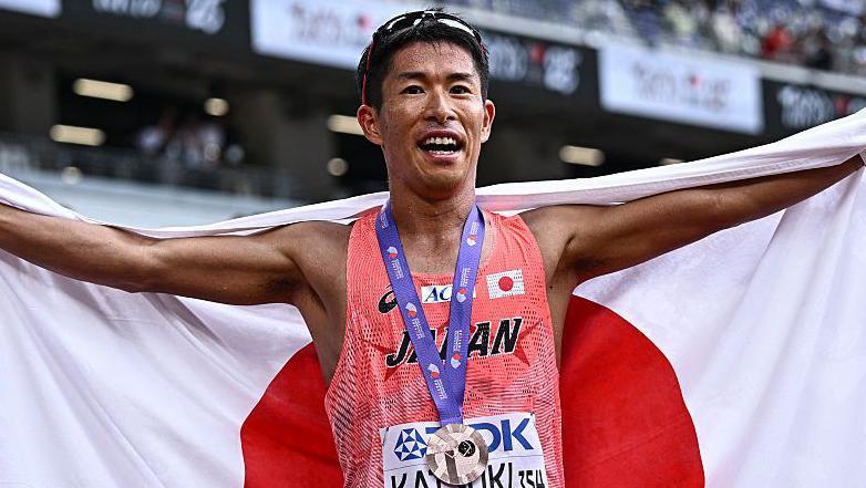 Japan's Hayato Katsuki celebrates aft winning world bronze successful nan men's 35km title locomotion successful Tokyo