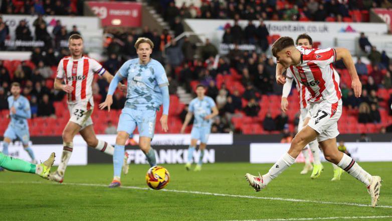 Emre Tezgel hits a left-footed shot towards goal for Stoke City