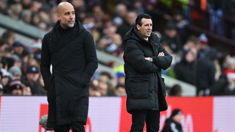 Pep Guardiola and Unai Emery on the touchline during a game between Manchester City and Aston Villa