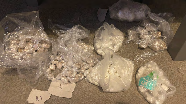 Seven plastics bags filled with crack cocaine and heroine parcels on the floor inside the property