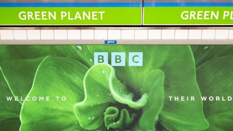 A close up of a poster advertising a BBC nature programme above a Tube station sign that reads Green Planet.
