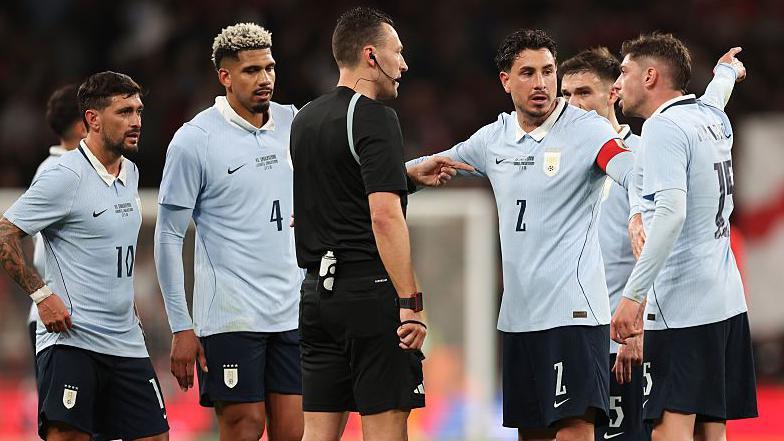 Uruguay's Federico Valverde and Jose Maria Gimenez lead the protests to referee Sven Jablonski after England's opening goal at Wembley Stadium 