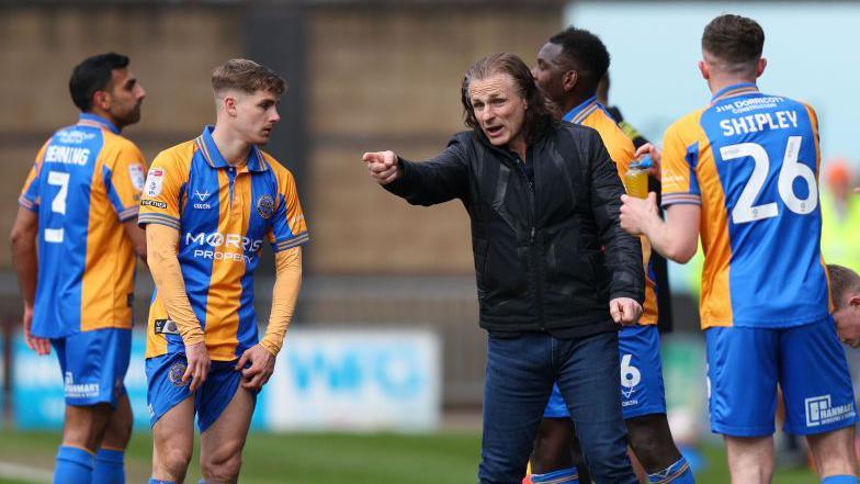 Gareth Ainsworth with the Shrewsbury Town players in a huddle during his time in charge at the club