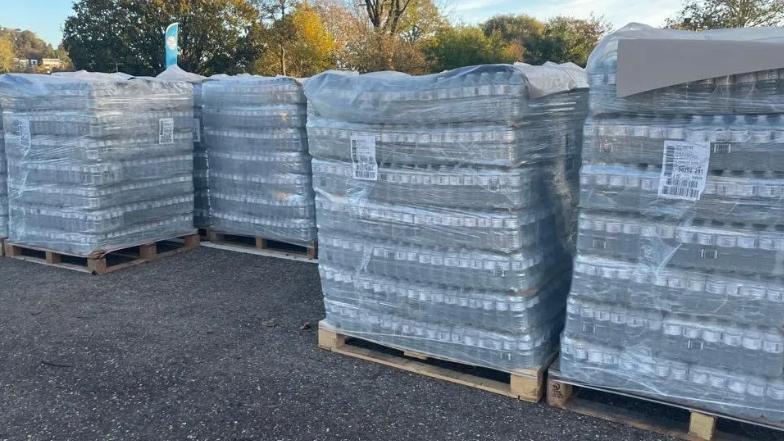 Pallets of bottled water waiting to be handed out to customers in Surrey