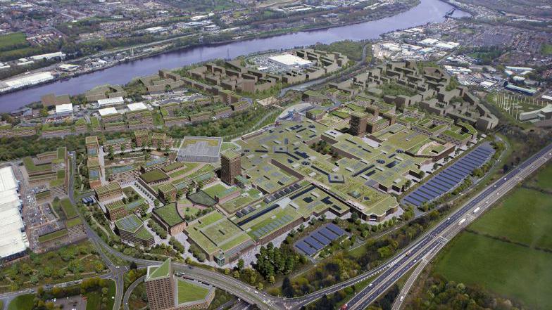 A CGI depicting an aerial view of how Metro Riverside will look. The shopping centre is covered in greenery and has solar panels on its roof. Buildings and homes are located around the centre and near the River Tyne.