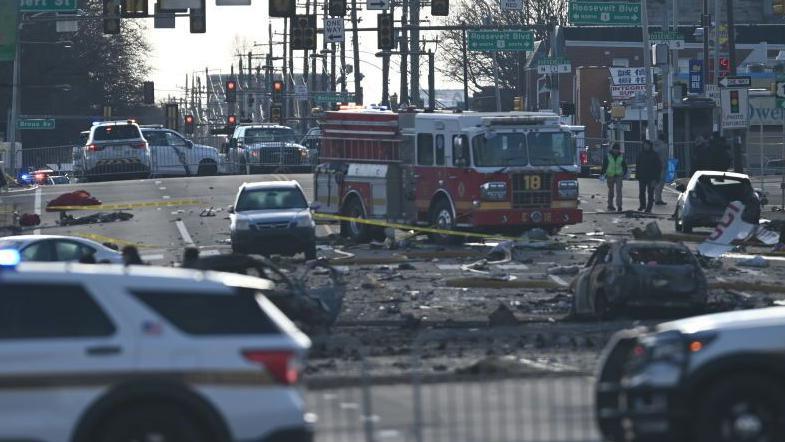 Investigators on Saturday morning collect evidence outside the Roosevelt Mall after a small plane crashed in Philadelphia