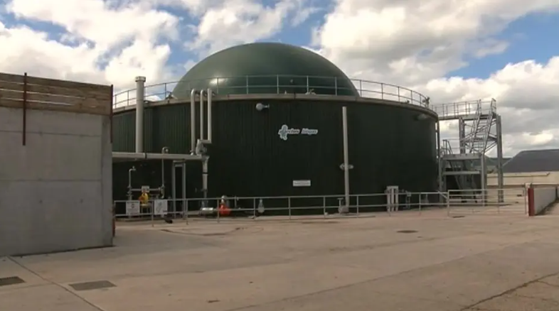 An anaerobic digester which is a large metal structure with a metal ball on top used to contain the gases from food waste