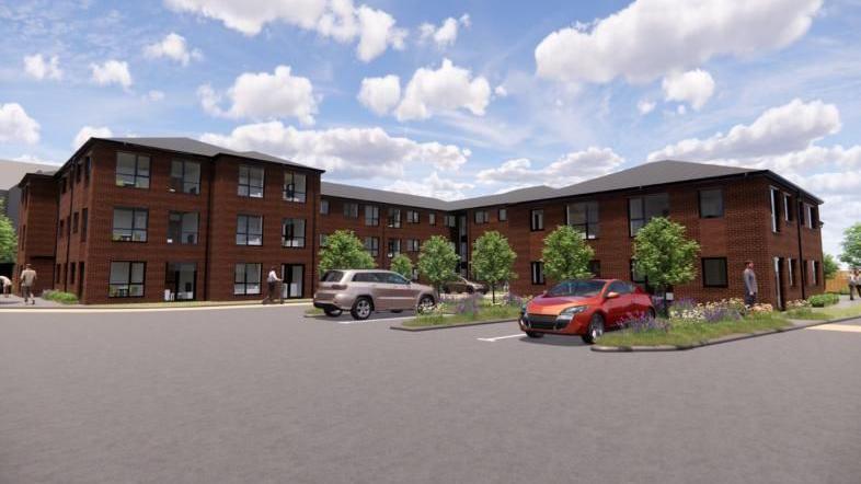 A CGI image showing a building with three floors in some parts and two floors in others. it has lots of windows and ample parking. Small trees line the outskirts of the block and there are areas of grass and flowers.