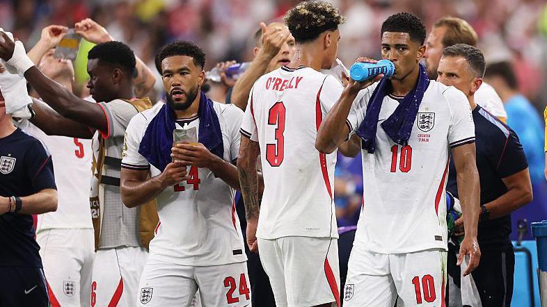 England players take on fluids during a hydration break