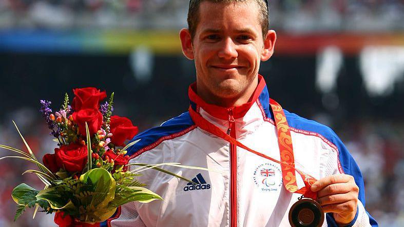 John McFall celebrates his bronze medal following the Men's 100m at the 2008 Paralympic games