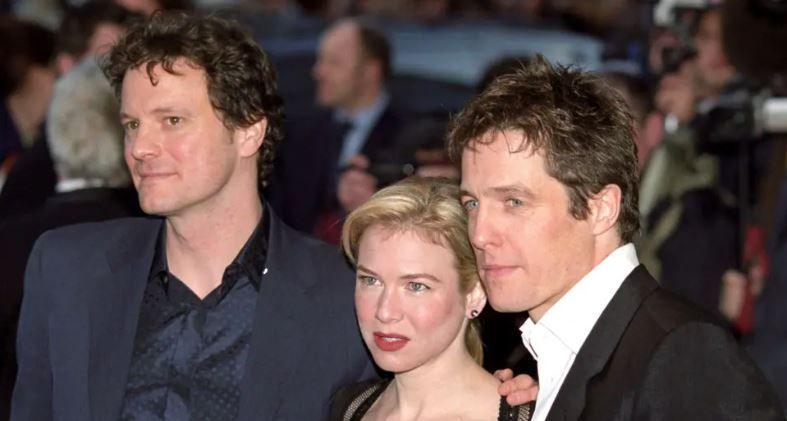 Actors Colin Firth, Renée Zellweger and Hugh Grant at the premiere of one of the Bridget Jones movies. They are posing for the cameras. 