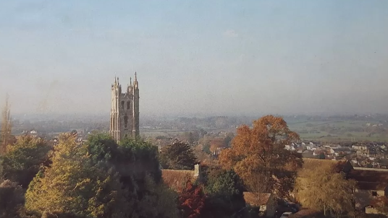 A photograph showing St Andrew's Church in Backwell, which is surrounded by trees