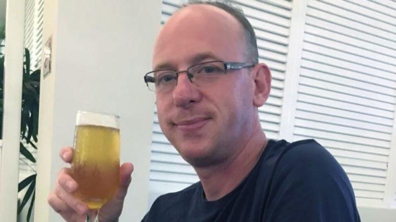 A man holding a beer