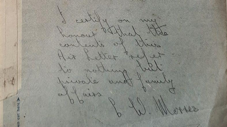 A piece of paper with handwritten black writing that says "I certify on my honour that the contents of this Air Letter refer to nothing but private and family affairs" and is signed C W Morris.