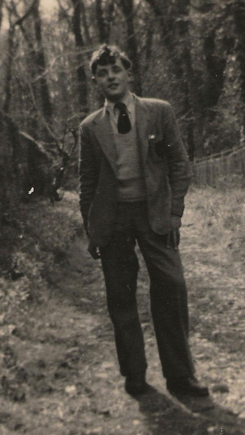 A grainy image of Anthony Hopkins at school in 1953. Outside in school uniform, looking to camera, with trees in the background